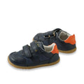The Bobux IW Iwalk Hunter Leather Sneaker Navy is a pair of navy kids' leather sneakers featuring perforated details, tan rubber soles, orange heel accents, and two adjustable straps. Displayed on a white background., 9420074834096, 9420074834102, 9420074834119, 9420074834126