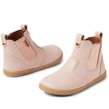 The Bobux IW Iwalk Jodhpur Leather Boot in Cameo Rose Pink features podiatrist-endorsed leather, elastic side panels, pull tabs, and tan rubber soles for toddlers, shown on a white background.
