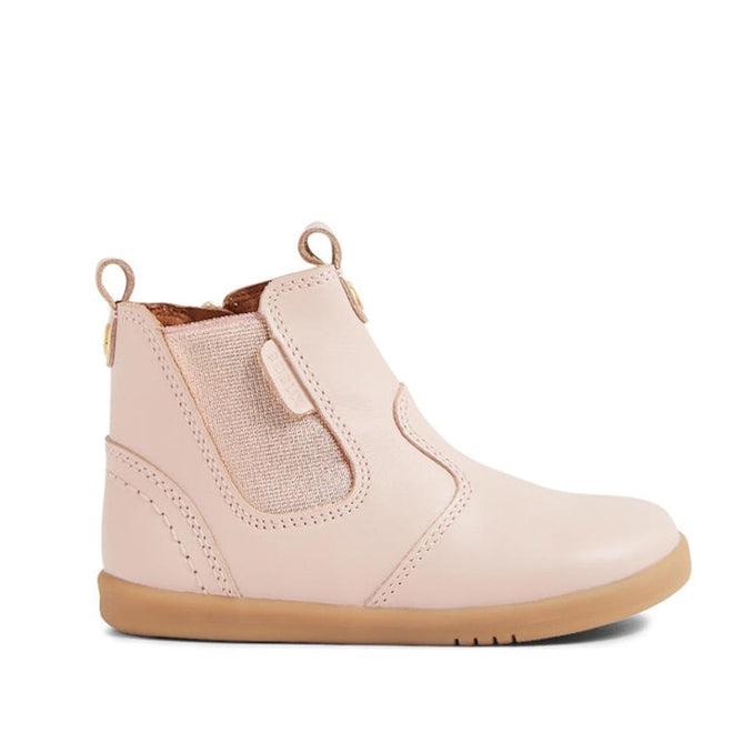 The Bobux IW Iwalk Jodhpur Leather Boot in Cameo Rose Pink is a podiatrist-endorsed kids’ ankle boot featuring light pink leather, tan elastic side panel, brown sole, pull tabs, and visible stitching., 9420068539617, 9420068539624, 9420068539631, 9420068539648, 9420068539655