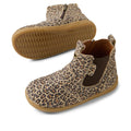 The Bobux IW Iwalk Jodhpur Leather Boot Leopard Shimmer features a brown sole, leopard print, side elastic panels, and zipper closure. One boot is upright; the other displays the textured sole. Podiatrist endorsed for little feet., 9420074802415, 9420074802422, 9420074802439, 9420074802446, 9420074802453