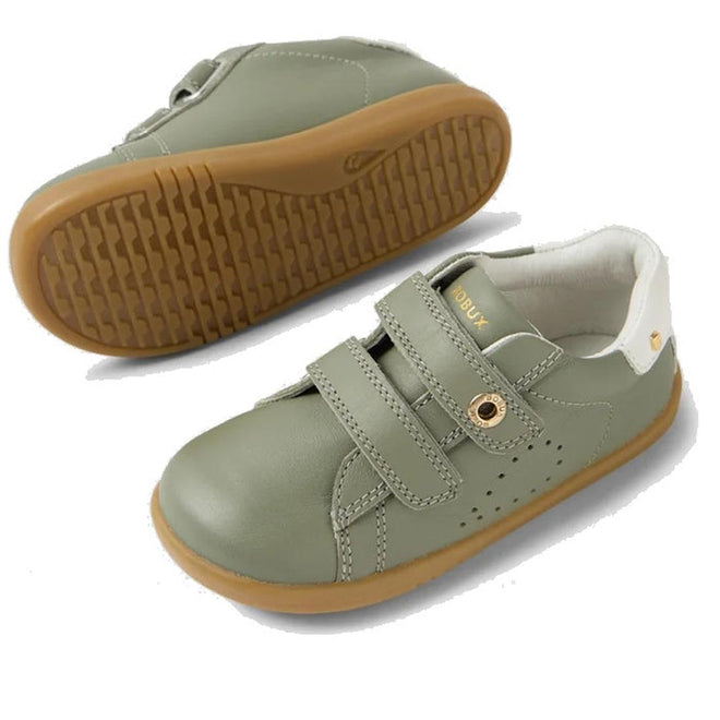The Bobux IW Iwalk Maverick Leather Sneaker in Vetiver Green features kids' leather uppers, tan rubber soles, white heel detail, perforated sides for breathability, and double adjustable straps. One shoe is shown side-on; the other displays the textured sole., 9420074836427, 9420074836434, 9420074836441, 9420074836458, 9420074836465