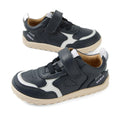 A pair of Bobux IW Iwalk Neo Toddlers Leather Sneakers in navy, featuring a barefoot design, white accents, Velcro straps, light brown zero-drop soles, and perforated detailing is displayed on a white background.