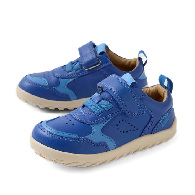 The Bobux IW Iwalk Neo Toddlers Leather Sneaker in Dazzling Blue features a barefoot-shaped toebox, light beige zero-drop soles for natural movement, Velcro straps, decorative stitching, and perforated details for added style and comfort.