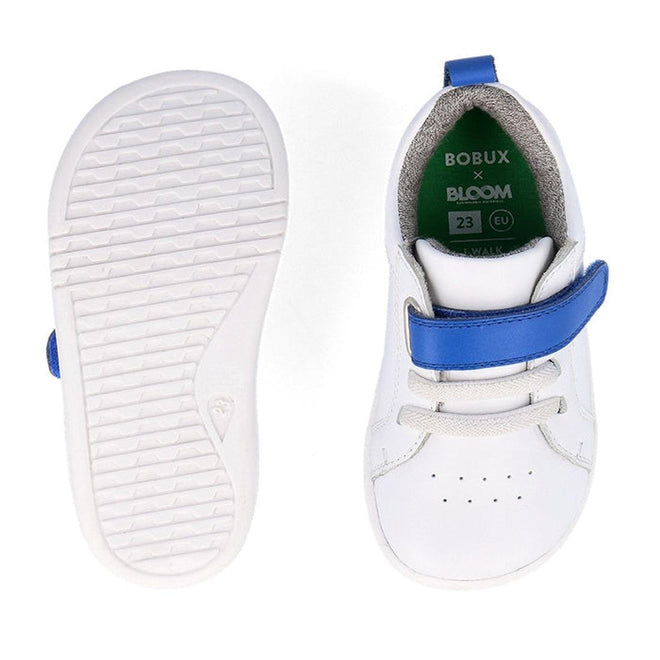 A pair of Bobux Kids IWalk IW Pace Sneaker White Blue 650401 are shown: one displays the insole with BOBUX x BLOOM branding and EU size 23, while the other shows the textured sole. Both feature blue straps on white leather., 9420075780583, 9420075779693, 9420075774582, 9420075781474, 9420075775077