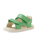 The Bobux IWalk Strand Sandal in Retro Green is a leather sandal for toddlers featuring adjustable Velcro straps and an open toe, displayed on a white background. Designed with comfort in mind, these sandals have a light beige, slightly textured sole.