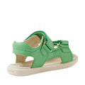 The Bobux IWalk Strand Sandal in Retro Green is shown angled from the back side, featuring an open heel and toe, gold buckles, and a beige sole. Made from washable leather with adjustable straps, these sandals are perfect for active toddlers.