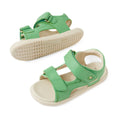 A pair of Bobux IWalk Strand Sandal Retro Green Open Toe toddlers leather sandals with beige soles, featuring adjustable straps and open toes, displayed on a white background.