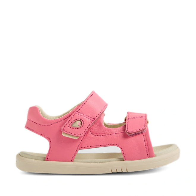 The Bobux IWalk Strand Sandal in Pink Lemonade is an open-toe toddler sandal, crafted from premium materials for lasting durability. Featuring two adjustable velcro straps for a secure fit and a comfortable beige sole, these stylish leather sandals are presented in a side profile against a white background.