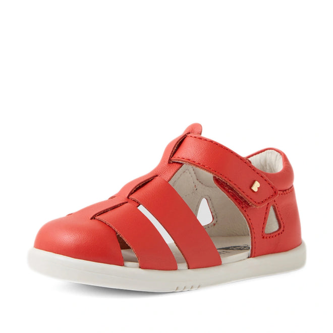 The Bobux IWalk Tidal Sandal in Grenadine Red, designed for toddlers, features a closed toe, white sole, and cut-out details on the sides and top. These water-friendly sandals offer a Velcro strap for easy fastening and include a soft, cushioned interior for all-day comfort., 9420074807755, 9420074807762, 9420074807779, 9420074807786, 9420074807793