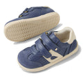 The Bobux IW Iwalk Titan Leather Sneaker in White Vintage Indigo Blue features Velcro straps and rubber soles; one shoe is upright, the other on its side to show the tread. Available in various sizes for toddlers., 9420074854292, 9420074854308, 9420074854315, 9420074854322, 9420074854339