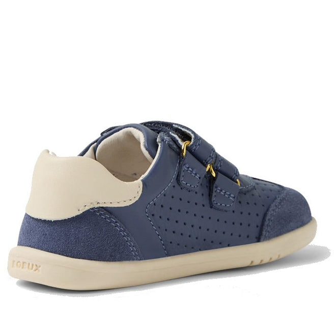 The Bobux IW Iwalk Titan Leather Sneaker in White Vintage Indigo Blue features Velcro straps, perforated detailing, and a flexible beige sole for toddlers. Shown from the back side angle and available in multiple sizes and colors., 9420074854292, 9420074854308, 9420074854315, 9420074854322, 9420074854339