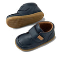 The Bobux IW Iwalk Grover Toddlers Navy Leather Boot features navy leather, tan rubber soles, white stitching, an adjustable Velcro strap closure, and a light brown inner lining, shown on a white background., 9420074832108, 9420074832115, 9420074832122, 9420074832139, 9420074832146