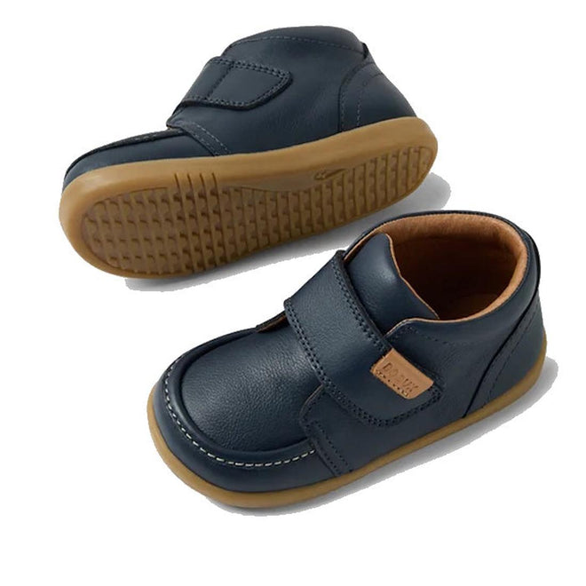 The Bobux IW Iwalk Grover Toddlers Navy Leather Boot features navy leather, tan rubber soles, white stitching, an adjustable Velcro strap closure, and a light brown inner lining, shown on a white background., 9420074832108, 9420074832115, 9420074832122, 9420074832139, 9420074832146