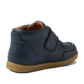 The Bobux IW Iwalk Grover Toddlers Navy Leather Boot features a tan rubber sole, visible stitching, and an adjustable strap. The kids' leather boot is pictured from the side and slightly behind., 9420074832108, 9420074832115, 9420074832122, 9420074832139, 9420074832146
