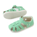 A pair of mint green, strappy closed-toe sandals for children—identified as the Bobux Iwalk IW Tropicana II Jelly Mint Green Leather Sandal—are displayed on a white background. One sandal stands upright while the other rests on its side to reveal the textured sole, showcasing these stylish and comfortable leather sandals that are ideal for little feet on the go., 9420074810038, 9420074810045, 9420074810052, 9420074810069, 9420074810076