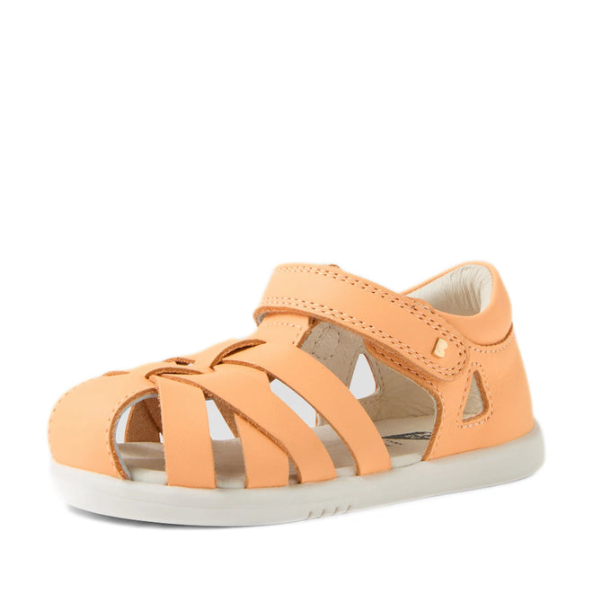 A light orange Bobux Iwalk IW Tropicana II Peach Jelly Leather Sandal for children, featuring an open-toe design with multiple straps and a secure Velcro closure, crafted for toddlers who seek comfort and style. Displayed on a white background.