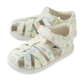 A pair of Bobux Iwalk IW Tropicana II White Floral Leather Sandals, designed for children with closed-toe protection, cut-out sides, pastel floral patterns, and easy Velcro straps—perfect for little explorers and shown on a white background.
