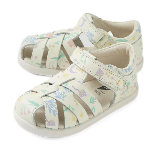 A pair of Bobux Iwalk IW Tropicana II White Floral Leather Sandals, designed for children with closed-toe protection, cut-out sides, pastel floral patterns, and easy Velcro straps—perfect for little explorers and shown on a white background.