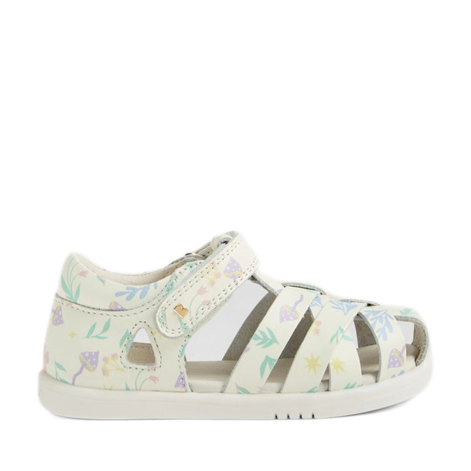 Introducing the Bobux Iwalk IW Tropicana II White Floral Leather Sandal—a children’s sandal inspired by the iconic Bobux Tropicana toddlers collection. This sandal features a white base adorned with a pastel floral and leaf pattern, a closed heel for added support, an open toe design, and an adjustable Velcro strap. Crafted from premium leather, it offers lasting comfort and breathability., 9420074810304, 9420074810311, 9420074810373, 9420074810380, 9420074810397