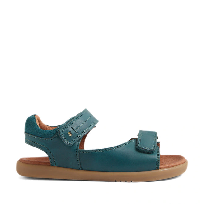 Mediterranean green leather open-toed sandals with adjustable Velcro straps at the ankle and toe, a cushioned brown footbed, and a flat tan rubber sole—shown in side profile on a white background—perfect for boys who want comfort and style, just like the Bobux KP Kids Plus Driftwood Leather Sandal., 9420074859013, 9420074858993, 9420074859006, 9420074858979, 9420074858962, 9420074858986, 9420074858955