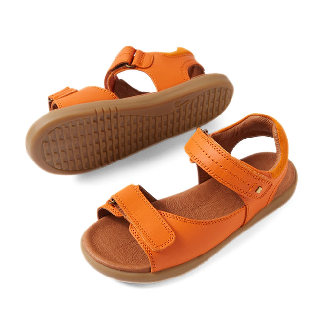 A pair of Bobux KP Kids Plus Driftwood Leather Sandal Orange Peel, featuring orange leather with brown soles and adjustable straps over the toes and around the ankle, displayed against a white background., 9420074859020, 9420074859037, 9420074859044, 9420074859051, 9420074859068
