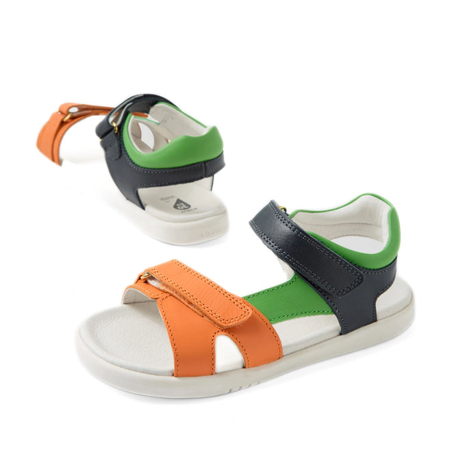 The Bobux KP Kids Plus Dune Leather Sandal Navy is featured from front and rear angles on a white background, showcasing its leather design with orange, green, and navy blue straps, white soles, and adjustable Velcro fastenings. These breathable summer shoes are perfect for active children.