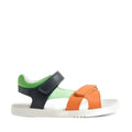 The Bobux KP Kids Plus Dune Leather Sandal Navy features a white sole, an orange strap across the toes, a green heel section, and black adjustable straps over the ankle and side, all displayed against a white background. These breathable summer sandals are designed to keep children’s feet comfortable throughout the season., 9420074855763, 9420074855787, 9420074855770, 9420074855756