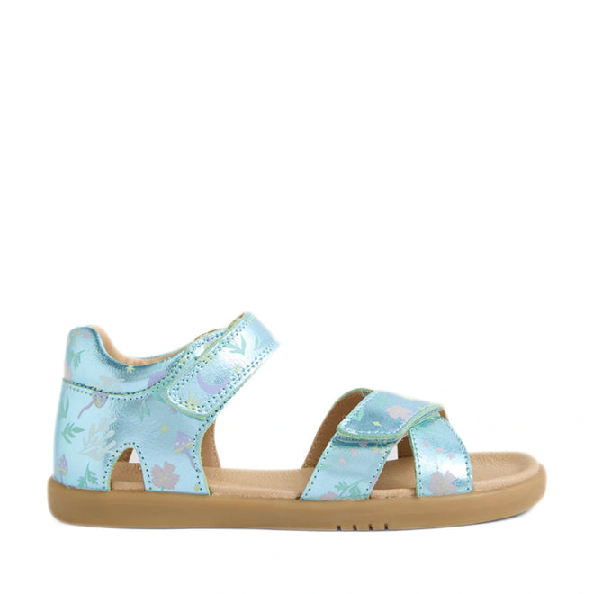 The Bobux KP Kids Plus Flora Leather Sandal in Jelly Mint Metallic Blue features a shiny metallic blue finish with floral patterns, adjustable Velcro straps, and a tan rubber sole, shown from the side.