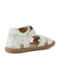 The Bobux KP Kids Plus Flora Leather Sandal in White Floral is an adjustable child’s sandal featuring a pastel flower print, open toe, ankle strap, and sturdy tan rubber sole—shown from the side and slightly behind.