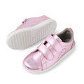 A pair of Bobux KP Kids Plus Grass Court 2 II Leather Sneakers in Pink Metallic, featuring two velcro straps, small side perforations, and white soles. Inspired by the original Grass Court design, these wide-fit leather shoes provide extra comfort for kids. One sneaker is shown upright while the other displays its textured grip sole.