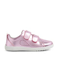 The Bobux KP Kids Plus Grass Court 2 II Leather Sneaker in Pink Metallic is a shiny pink leather sneaker for kids featuring two velcro straps, a white sole, and small perforations on the side forming a dotted heart shape. Designed in a wide fit for extra comfort, this style draws inspiration from the classic Bobux Grass Court collection.