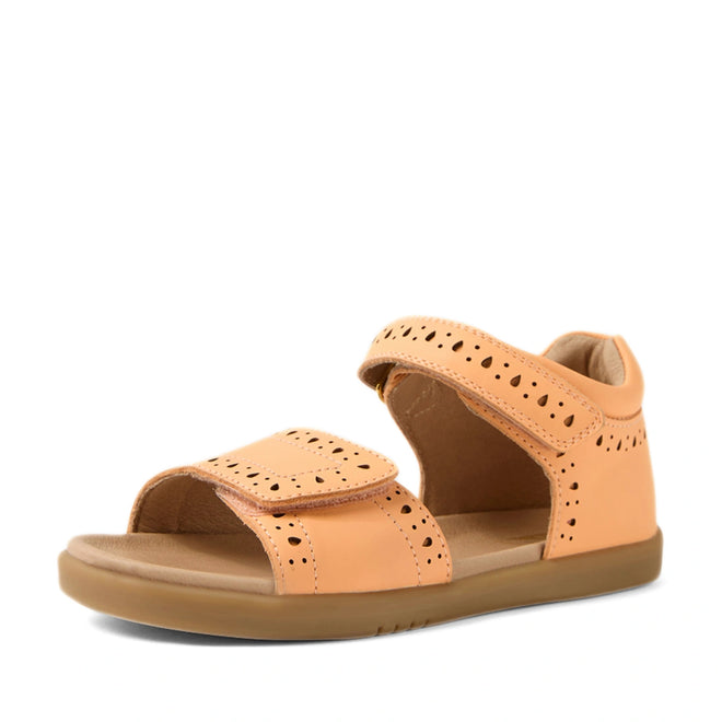 Introducing the Bobux Kid+ Plus KP Logan Peach Jelly Open Toe Sandal: This stylish kids’ sandal in a peach jelly hue features an open toe, two adjustable hook-and-loop straps for a secure fit, perforated detailing, and a cushioned brown sole. Displayed against a white background, these leather sandals combine comfort and support for little feet with their adjustable straps and supportive design.