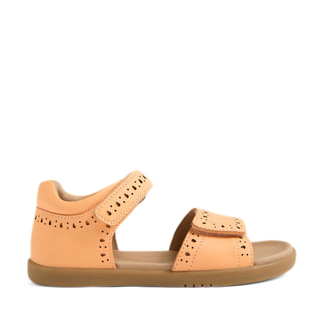 The Bobux Kid+ Plus KP Logan Peach Jelly Open Toe Sandal is a peach-toned children’s sandal featuring perforated detailing, Velcro adjustable straps at the ankle and toe, and a flat sole designed for comfort and casual wear.