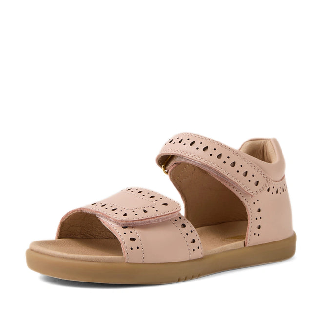 Here’s the rewritten sentence using the provided product data: A single Bobux Kid+ Plus KP Logan Cameo Rose Pink Open Toe Sandal for girls, crafted from premium leather with a closed heel, open toe, perforated detailing, and two adjustable Velcro straps, displayed on a white background.