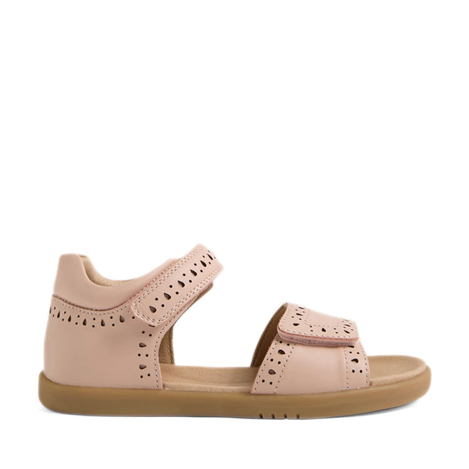 A single Bobux Kid+ Plus KP Logan Cameo Rose Pink Open Toe Sandal featuring stylish cut-out patterns, an open toe, adjustable Velcro toe and ankle straps, and a comfortable flat rubber sole—ideal for little feet looking for both comfort and classic leather sandal style.