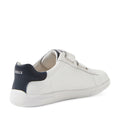 The Bobux Kid+ Plus KP Maverick Leather Sneaker in White Navy is pictured from a rear side angle on a white background, featuring white leather, a navy heel accent, an adjustable Velcro strap, and “BOBUX” branding on the back., 9420074860217, 9420074860224, 9420074860231, 9420074860248, 9420074860255