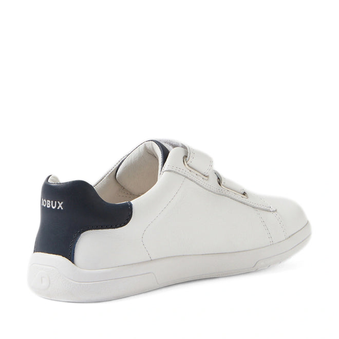 The Bobux Kid+ Plus KP Maverick Leather Sneaker in White Navy is pictured from a rear side angle on a white background, featuring white leather, a navy heel accent, an adjustable Velcro strap, and “BOBUX” branding on the back., 9420074860217, 9420074860224, 9420074860231, 9420074860248, 9420074860255