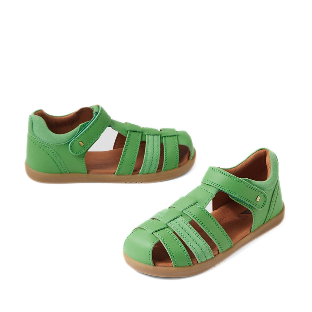 A pair of Bobux Kid+ Plus Roam Retro Green Closed Toe Sandals with tan soles and adjustable Velcro straps, displayed on a white background—perfect kids’ summer shoes crafted from quality leather for comfortable everyday wear.