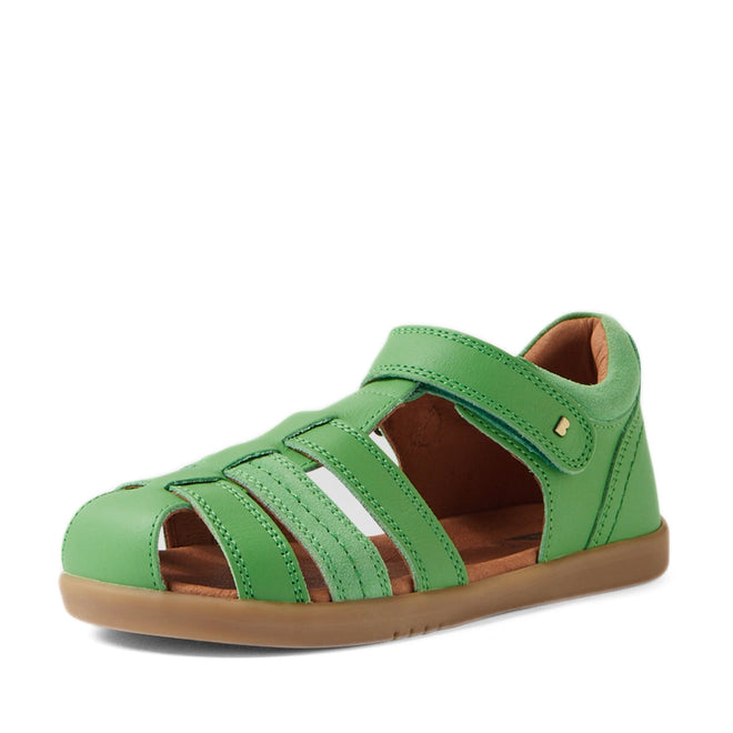 Introducing the Bobux Kid+ Plus Roam Retro Green Closed Toe Sandal—a stylish green children’s sandal featuring a closed toe, open sides, and an easy Velcro strap, making it ideal for kids’ summer wear. The design includes a brown sole with distinctive white and green side details, inspired by the signature look of the classic Bobux Roam Juniors Sandals., 9420074808059, 9420074808028, 9420074808042, 9420074808035