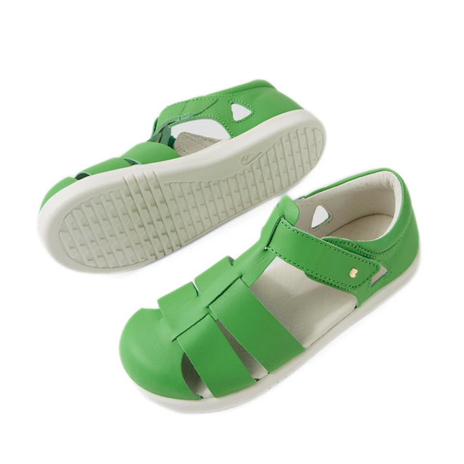 A pair of Bobux Kid + Plus Tidal Closed Toe Quick Dry Sandals in Retro Green, featuring white soles—one displayed from the side and the other showing the tread pattern from below. These stylish leather sandals are perfect for active kids, offering comfort and protection for every adventure., 9420074809469, 9420074809476, 9420074809483, 9420074809438, 9420074809452, 9420074809445