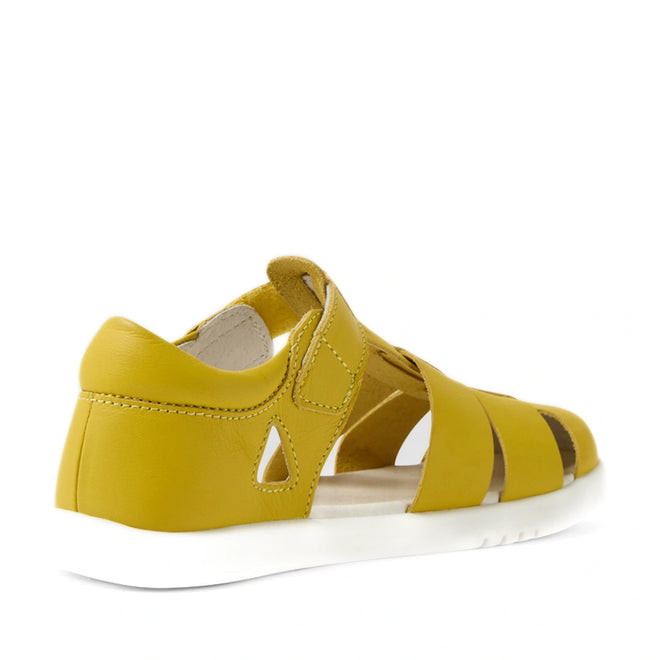 The Bobux Kid+ Plus Tidal Closed Toe Quick Dry Sandal in Mango Mint is a yellow closed-toe sandal with a white sole, open sides, a closed heel, and a Velcro strap—perfect water-friendly footwear for active days—shown here from the back left angle against a white background., 9420074809643, 9420074809650, 9420074809667, 9420074809674, 9420074809681