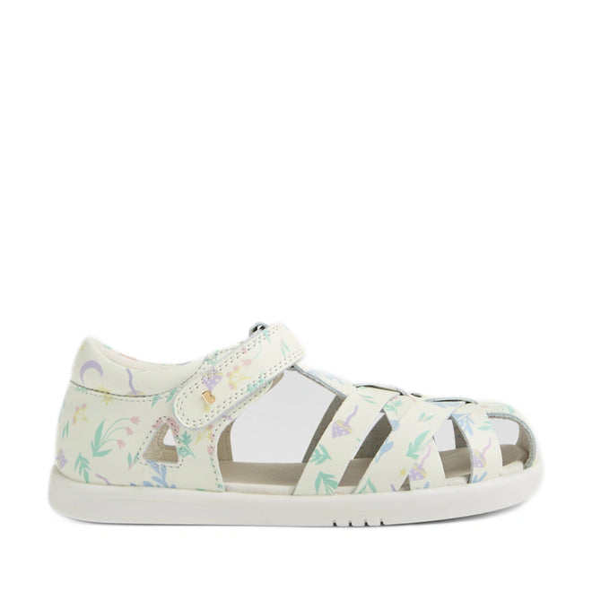 The Bobux Kids Plus KP Tropicana II White Floral Quick Dry Sandal is a white closed-toe sandal for kids, featuring a secure Velcro strap and crafted in the style of classic leather sandals. Adorned with pastel floral and nature-inspired patterns in purple, green, and yellow, it offers both comfort and charm. The lightweight design is complemented by a white sole with subtle grip for added stability, making this sandal perfect for everyday wear.