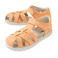 A pair of Bobux Kids Plus KP Tropicana II Peach Jelly Quick Dry Sandals, featuring a peach color, closed-toe leather design with velcro straps and white soles, displayed on a white background. These podiatrist-approved kids’ shoes combine comfort and style for little feet.