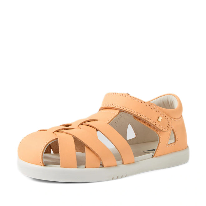 A single Bobux Kids Plus KP Tropicana II Peach Jelly Quick Dry Sandal, a podiatrist-approved kids’ shoe in peach with a closed toe, cut-out sides, and an ankle Velcro strap, is displayed on a white background., 9420074861368, 9420074861337, 9420074861344, 9420074861351, 9420074861375
