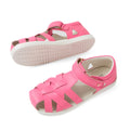 Two pink Bobux Kids Plus KP Tropicana II Pink Lemonade Quick Dry Sandals for children, featuring closed toes, woven straps, white soles, and a hook-and-loop strap. Perfect as kids’ summer shoes, these sandals combine style and comfort. One sandal is shown upright while the other displays the sole., 9420074861153, 9420074861146, 9420074861139, 9420074861160, 9420074861122