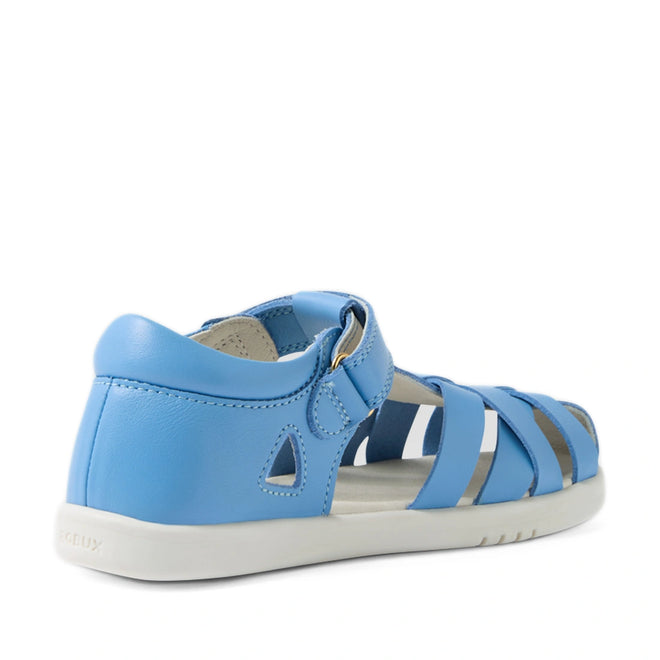 The Bobux Kids Plus KP Tropicana II Baltic Sea Blue Quick Dry Sandal is a light blue children’s summer sandal inspired by the classic Tropicana style, featuring a closed heel, open toe, multiple straps, and a white sole. Viewed from the back side, this shoe offers an ankle buckle closure for a secure and comfortable fit., 9420074861269, 9420074861276, 9420074861283, 9420074861290
