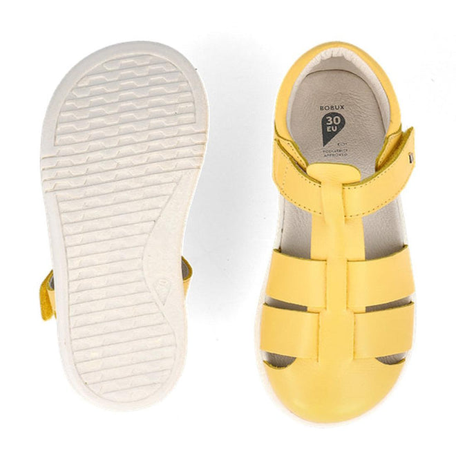 The Bobux Kids Plus KP Tidal Quick Dry Sandal in Pineapple Yellow (834418) features closed toes, white rubber soles, and a size label showing 30 EU—ideal unisex summer footwear with one sandal top view and the other showing its textured sole., 9420075780033, 9420075774032, 9420075779822, 9420075768949, 9420075775954, 9420075775381, 9420075777040