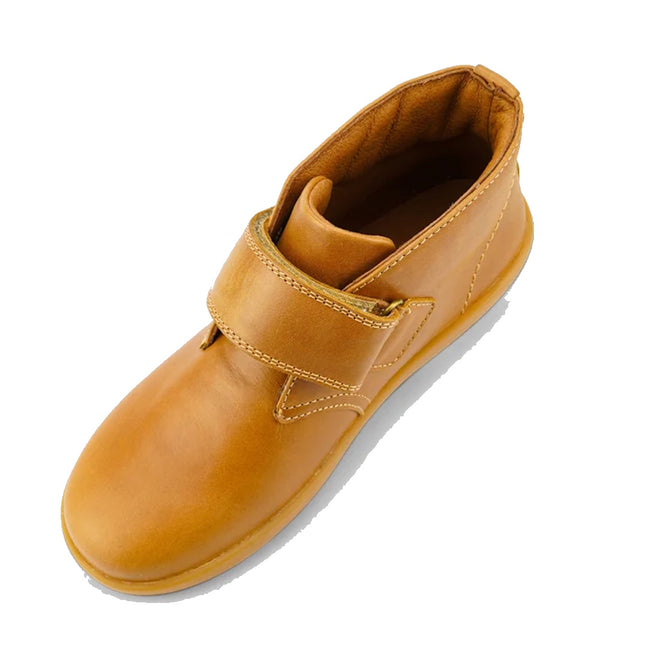 The Bobux Kid+ Desert Boot Caramel 830305Z top down view is a brown leather unisex children’s high-top boot with a tan rubber sole and wide hook-and-loop strap, shown in side profile against a white background., 9420068516861, 9420075719682, 9420075719699, 9420068516892, 9420068516908, 9420068516915, 9420068516922