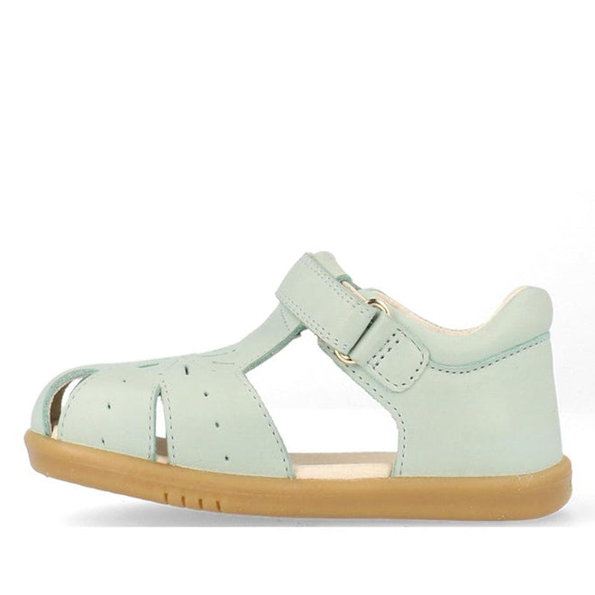 The Bobux Iwalk IW Compass Kids Mist Blue Leather Sandal 641205 is a closed toe toddler sandal in mist blue with side cutouts, buckle strap, and light brown rubber sole—ideal summer footwear for little ones., 9420075708464, 9420075708471, 9420075708488, 9420075708495, 9420075708501