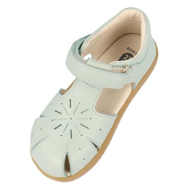 The Bobux Iwalk IW Compass Kids Mist Blue Leather Sandal 641205 features light blue leather, a tan sole, closed toe, front cutouts, and an adjustable hook-and-loop ankle strap—perfect summer sandals for little ones., 9420075708464, 9420075708471, 9420075708488, 9420075708495, 9420075708501